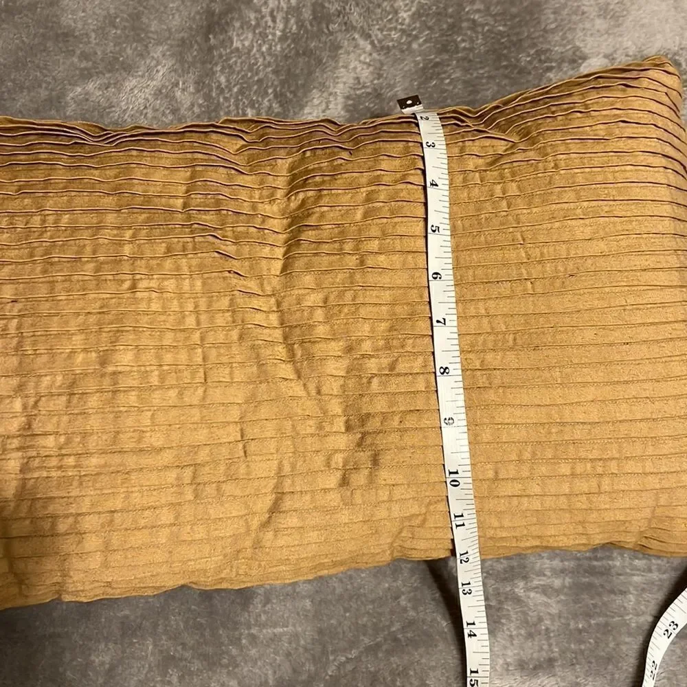 Tan/brown pillow. One side pleated/one side buttons